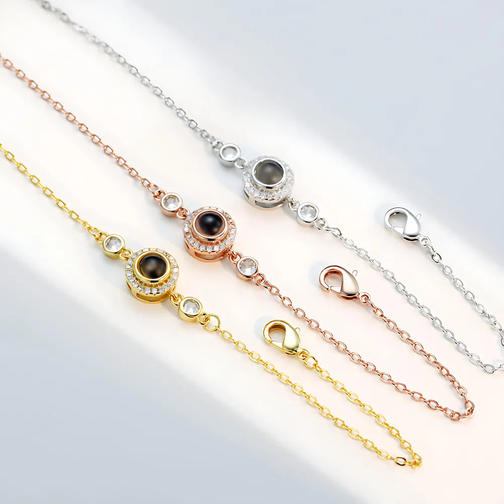 Three gold, rose gold, and silver bracelets with gemstone accents on a light gray background.