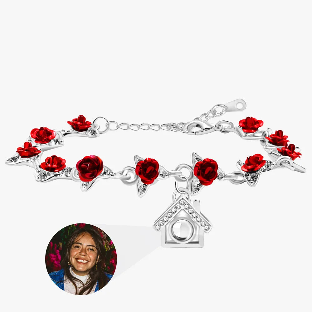 Silver bracelet with red rose charms on a white background