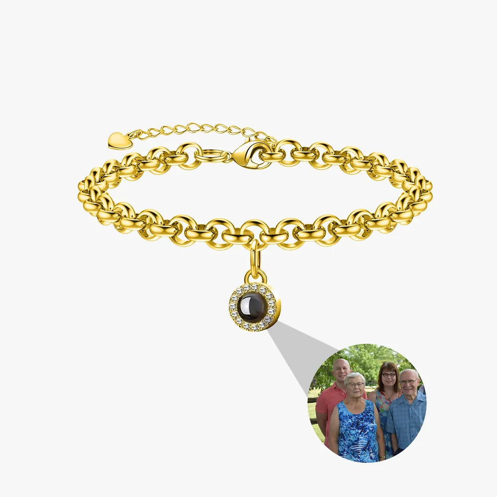 Gold bracelet with a photo charm on a white background
