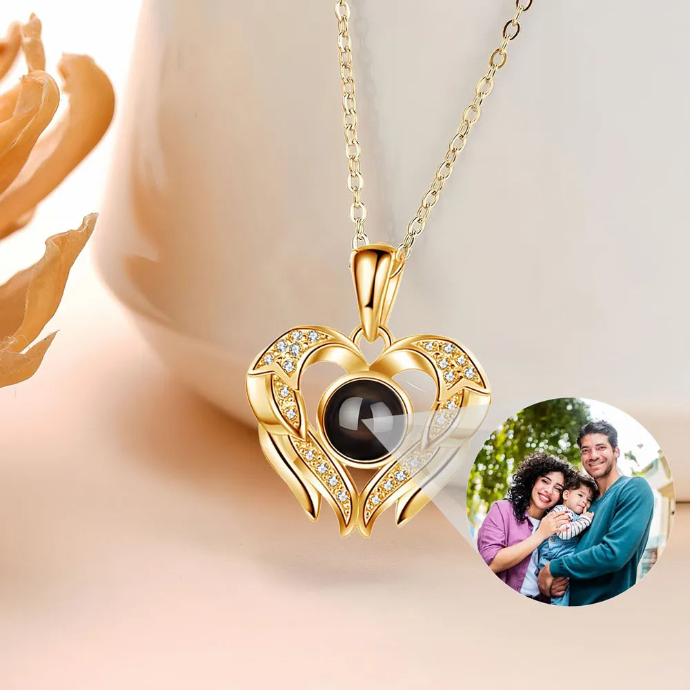 Gold heart-shaped necklace with a black gemstone on a light background