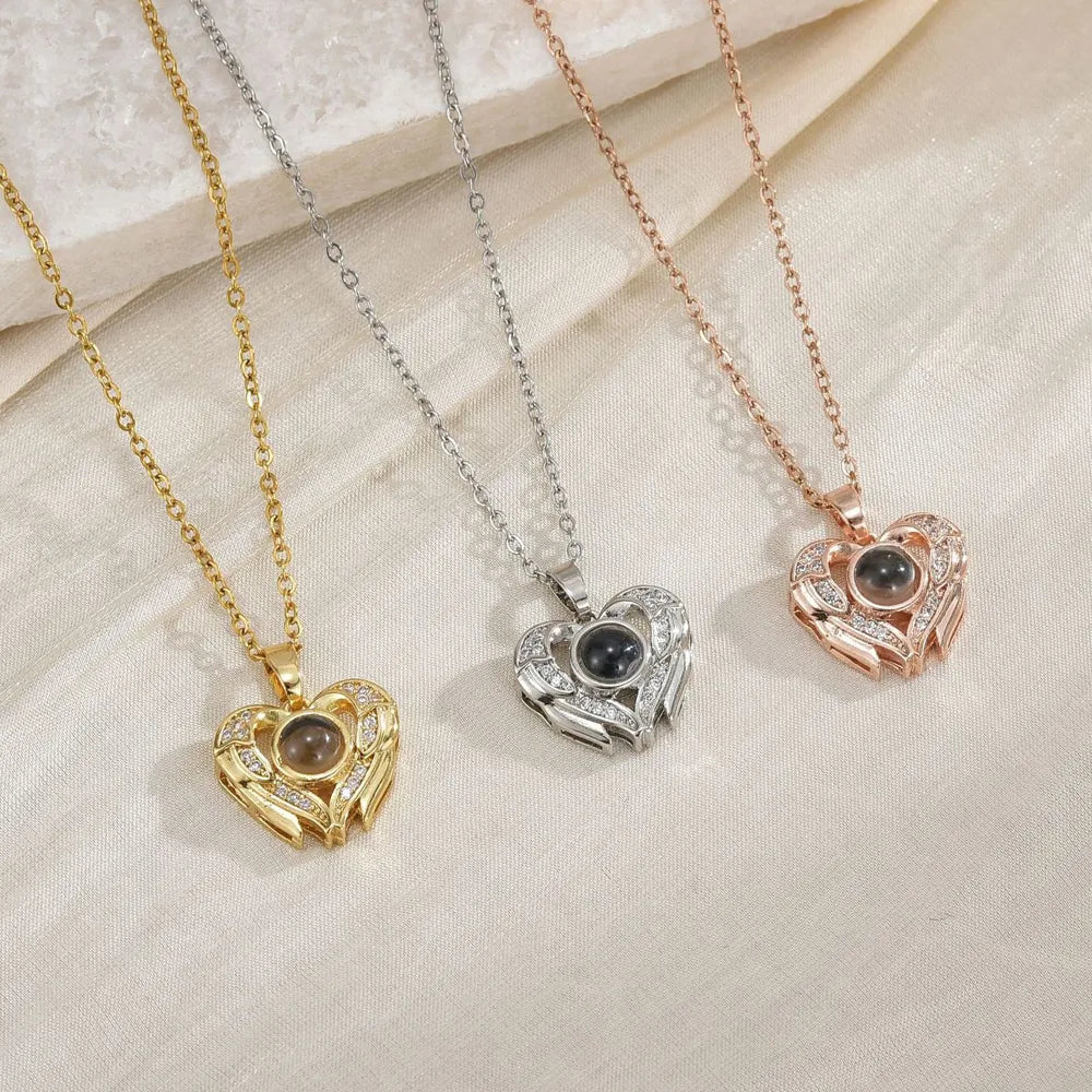 Three heart-shaped pendants on chains against a textured beige background