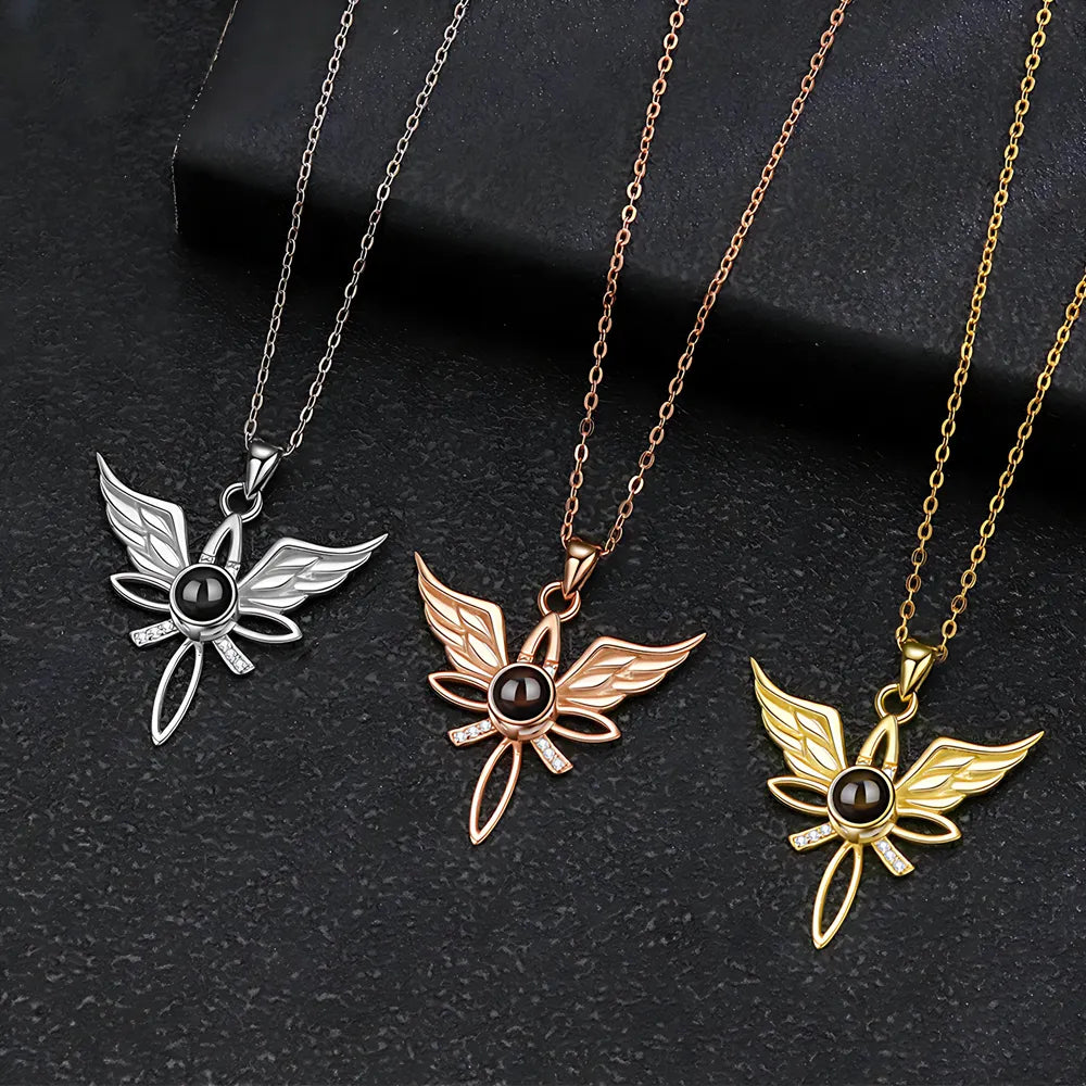 Three butterfly-shaped pendants on chains against a dark background