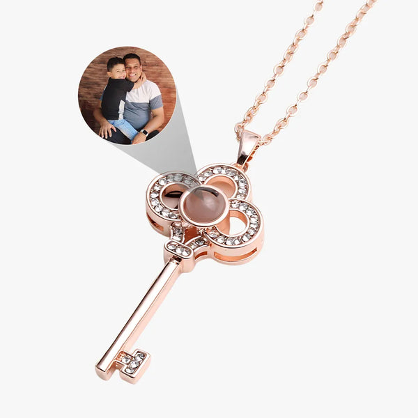 Rose gold key-shaped necklace with a heart pendant on a white background